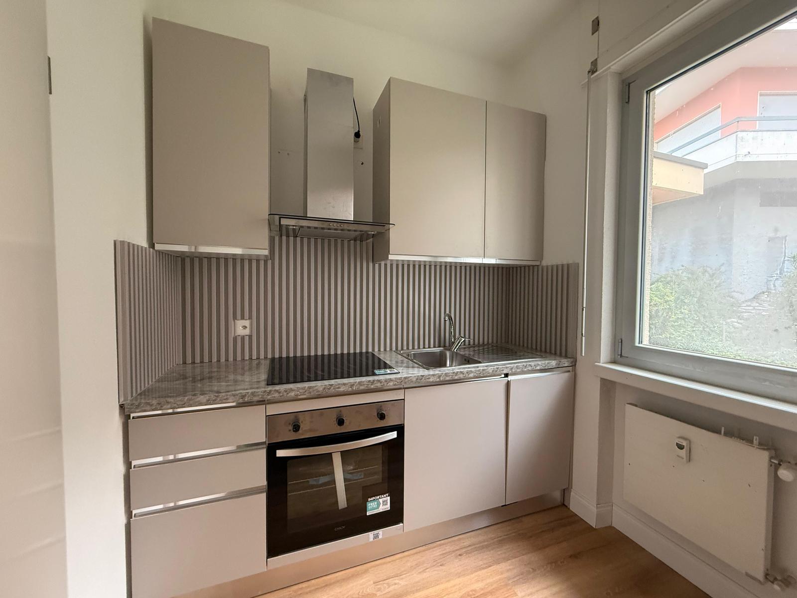 Cucina lineare con piano cottura e cappa